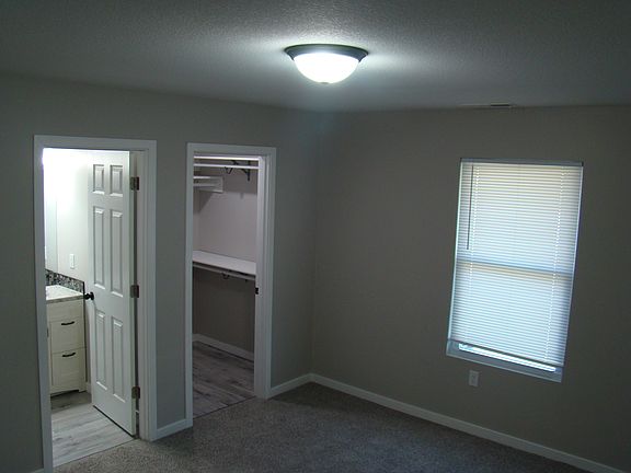 View of master bath and walk in closet from master bedroom