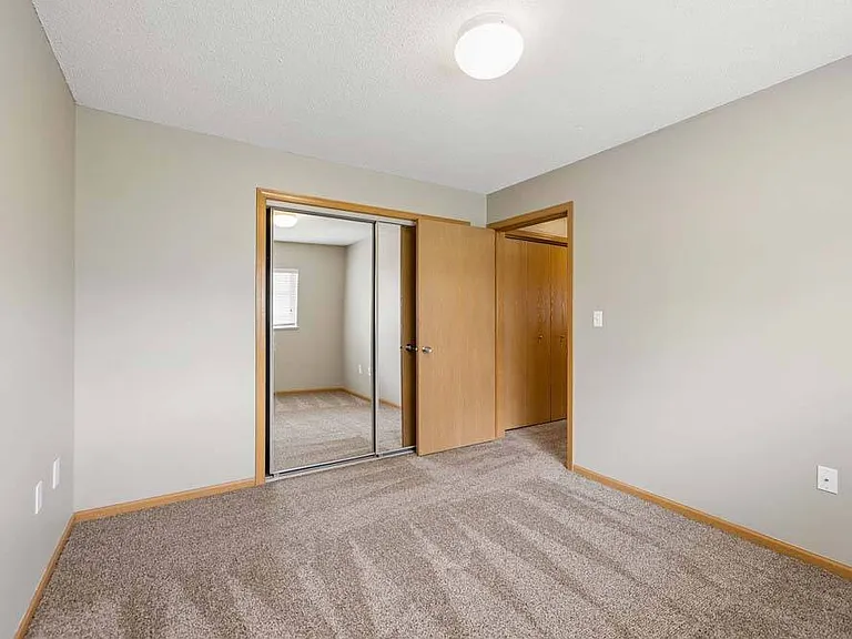 Enjoy a restful retreat with a spacious bedroom featuring generous closet space and a warm, inviting feel.