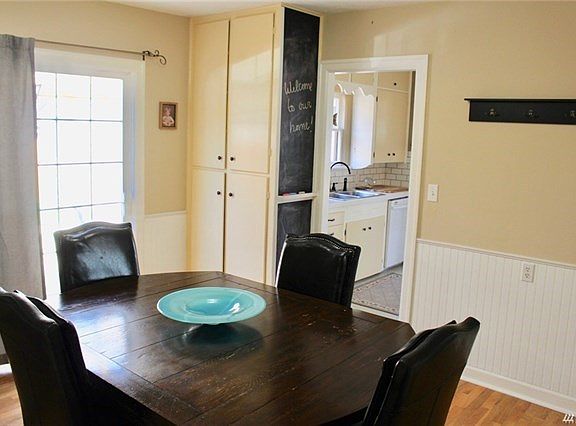 Ample dining room off kitchen with hardwood floors, wainscotting and slider to private court yard and covered patio, extending your living space to the outdoors.