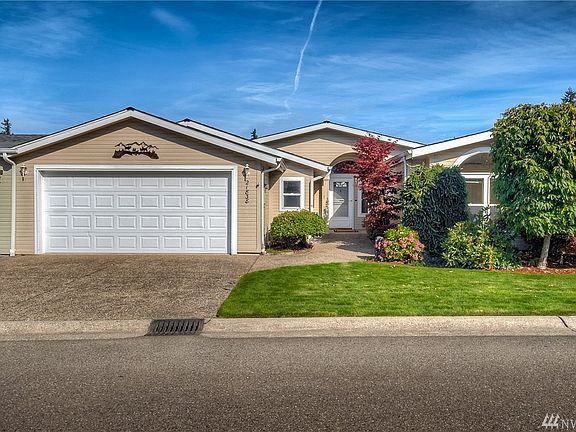 Front of the home beautifully landscaped.