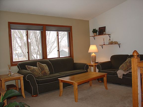Sun-filled living room w/ grand backyard view.