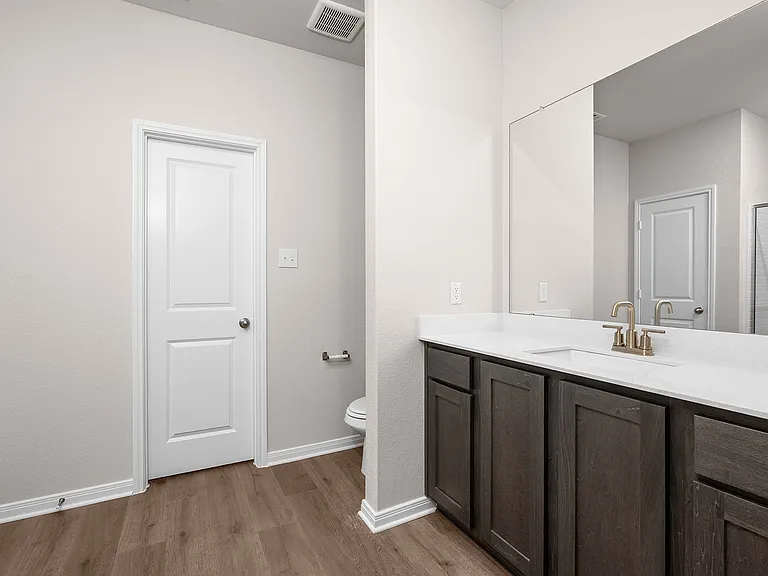 The master bathroom has a sprawling vanity.