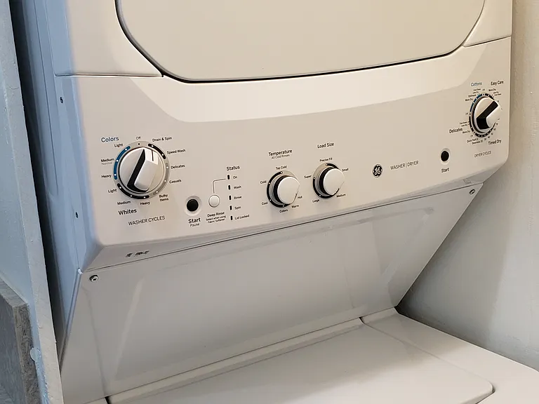 Washer and dryer, inside laundry closet area.