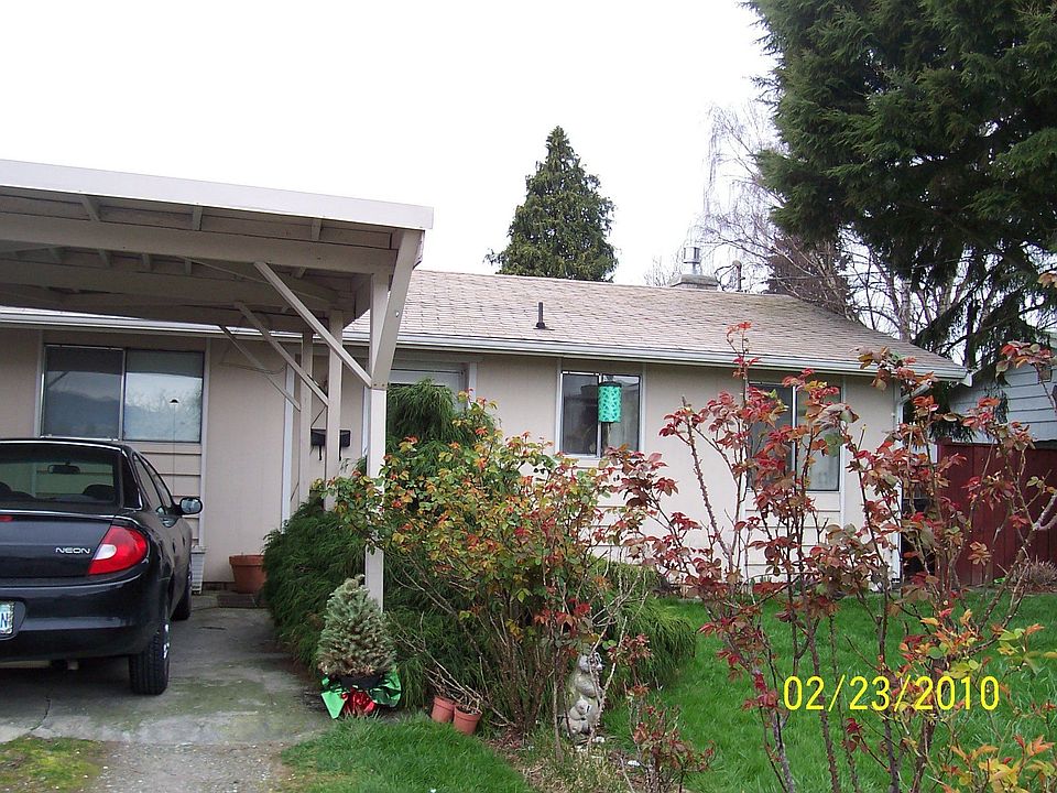 Front with carport & rose garden