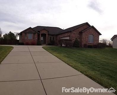 View from family-friendly street
						:
						Beautiful ranch with swing-entry garage and expanded driveway. Large front yard.