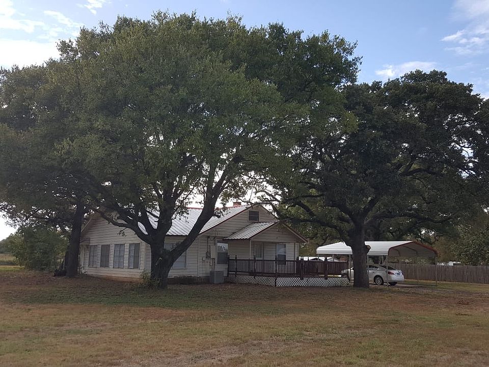Beautiful mature trees help keep the house cool.