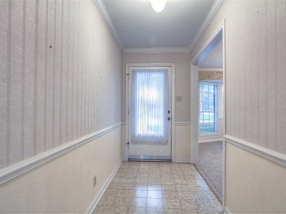 The front door opens into a generous foyer with access to the formal dining room.