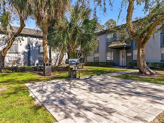 Relax and enjoy the outdoor living space surrounded by lush greenery and modern amenities.