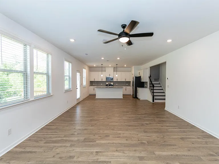 Spacious kitchen offering an elegant path to the stairwell.
