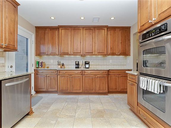 NEVER WANT FOR MORE CABINET SPACE IN THIS WELL-APPOINTED KITCHEN AND ENJOY THE CONVENIENCE OF THE DOUBLE OVENS!