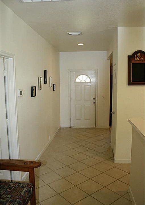 The entry has large tile flooring.