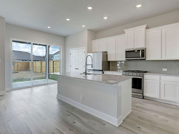 Chef-ready kitchen with a large granite island.