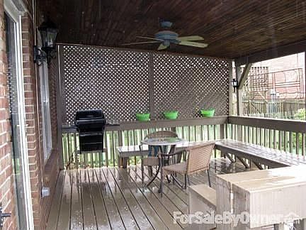 Covered Deck : Privacy wall, built-in grill and benches next to brick patio