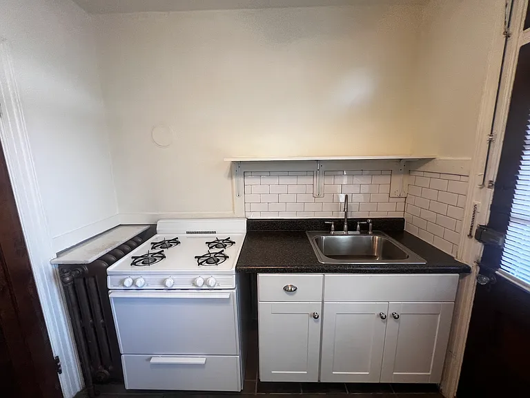 Large gas range and updated kitchen sink area.