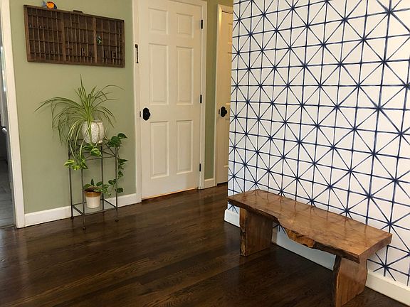 Viewing front entry towards closet and door to lower level. All doors are solid wood.