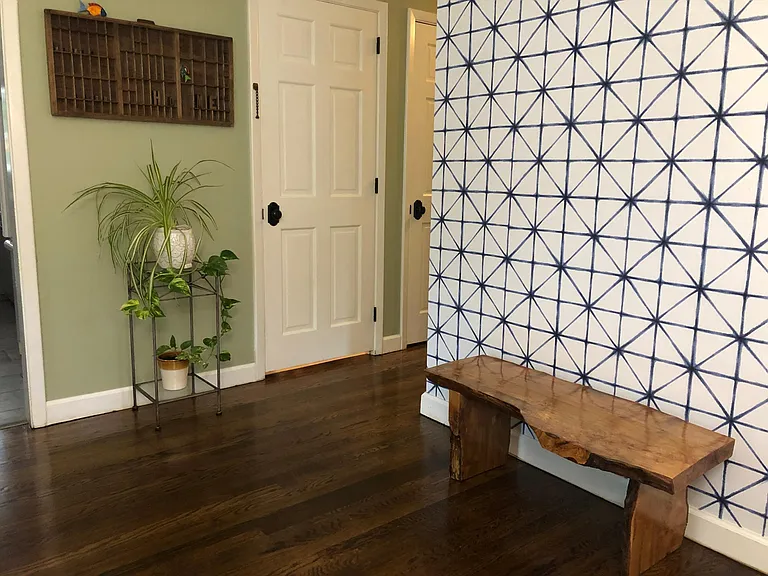 Viewing front entry towards closet and door to lower level. All doors are solid wood.