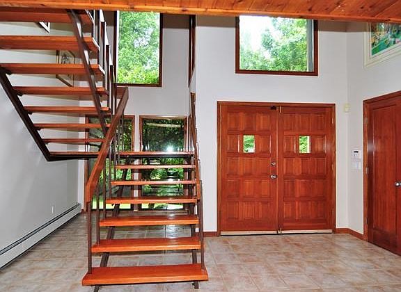 Dramatic entry hall with double coat closet and plenty of windows to let the natural light in.