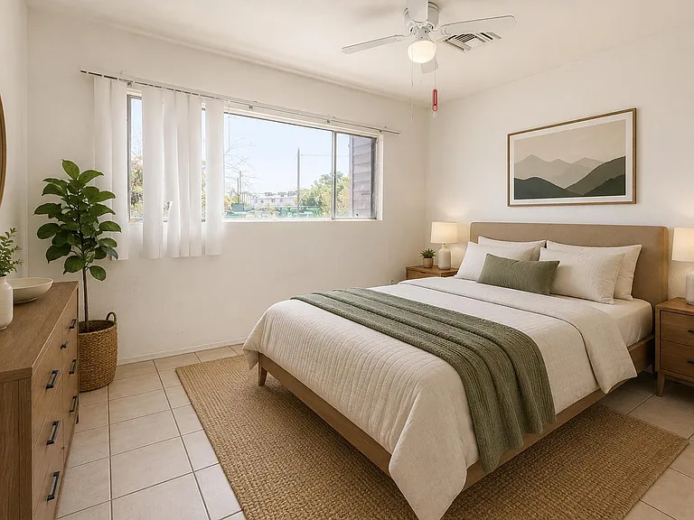 Well-sized bedroom with a large window, ceiling fan, and ample space for a full bedroom set plus dresser storage.