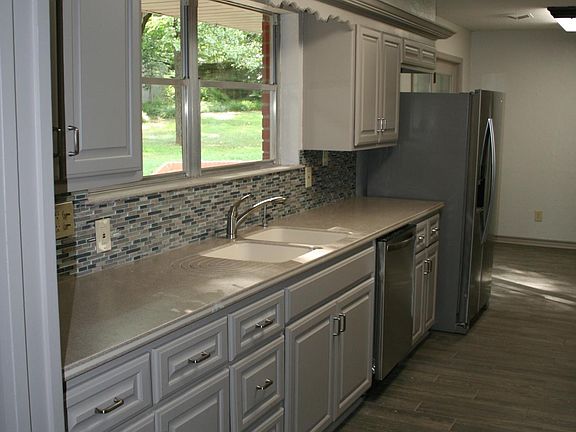 Kitchen with solid surface top and custom back splash