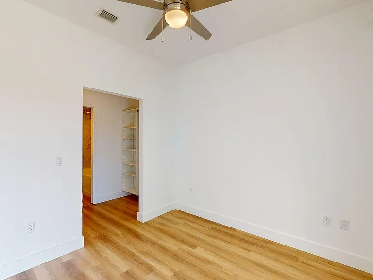 Spacious apartment Bedroom with Large Closet and Wood Style Flooring.