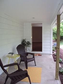 This covered porch has a private view of the backyard and Sturgeon Creek.
