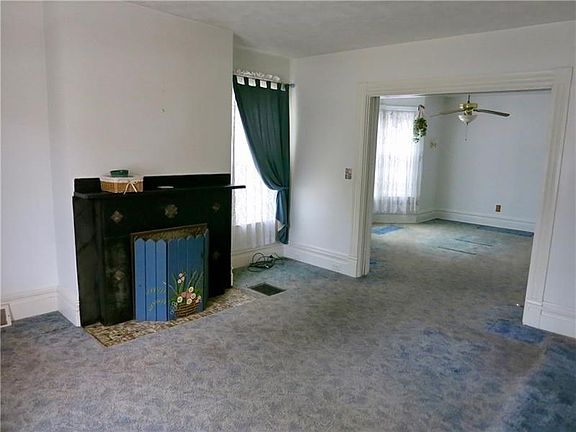 Large, cozy 15x13 living room with original mantel decor!