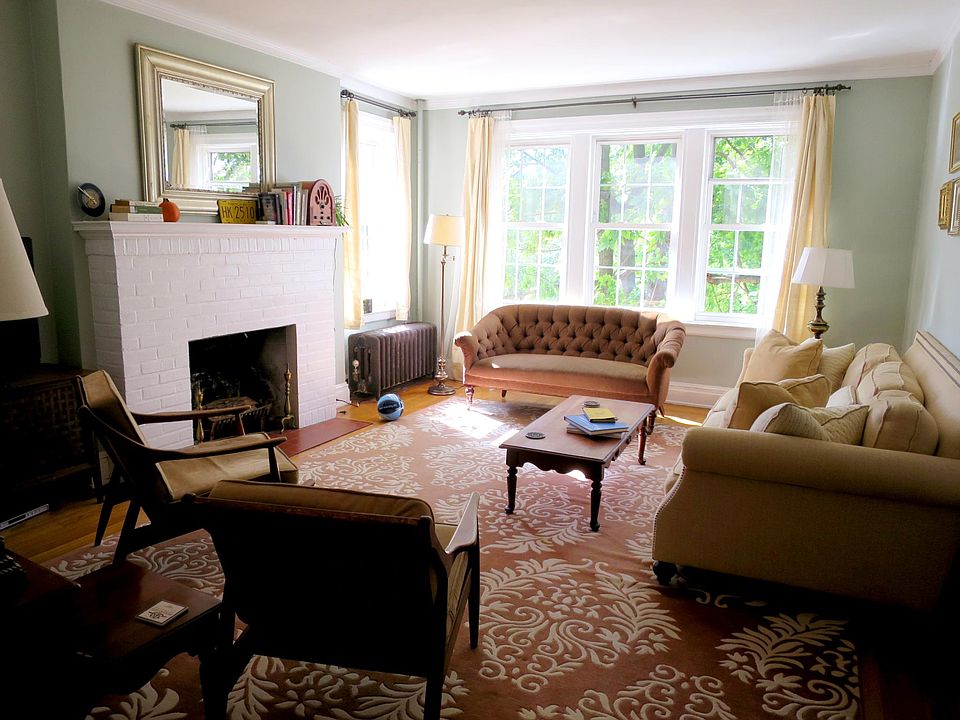 Bright, oversized living room with large windows, fireplace and closet