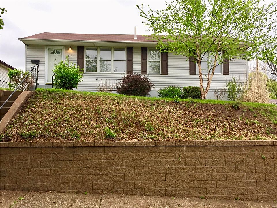 View of home and staircase from street level. Home sitting higher than the street provides additional privacy and unobstructed sun exposure from the south facing living room, bathroom and front bedroom windows.