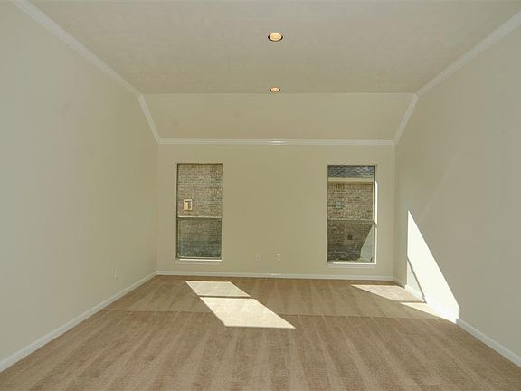 Formal study or dining room with crown molding and great natural light.