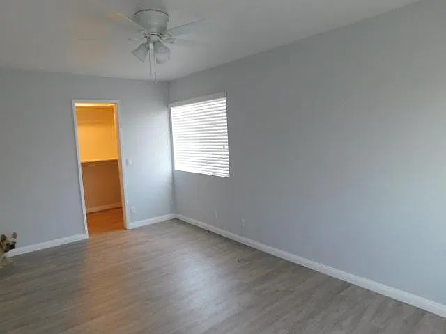 Master Bedroom Walk in Closet with Closet Organizers & ceiling fan in bedroom