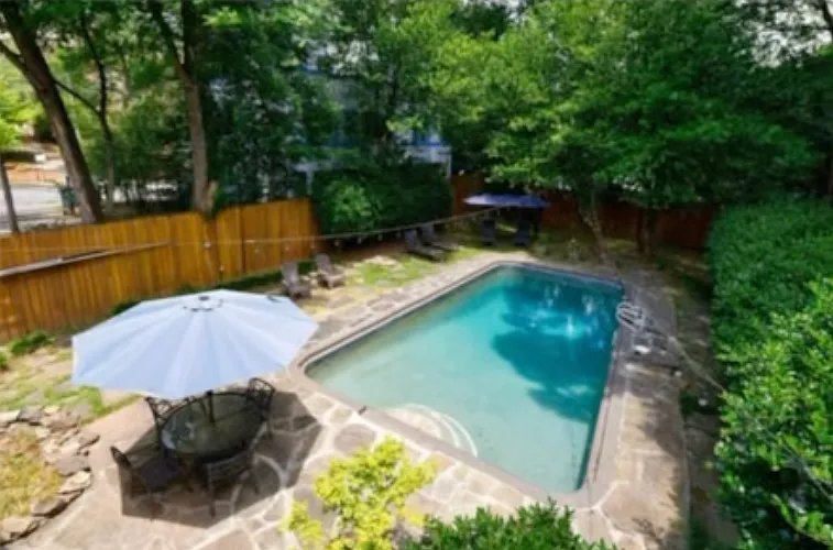 Huge backyard with ample green space, a back patio and pool, shared with unit B