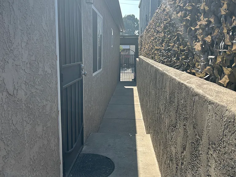 View of walkway towards alley