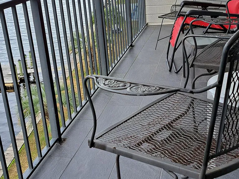 Waterway view balcony with settee 2 seater glider and two high chairs and tables