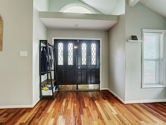 There are high ceilings and wood flooring in the living room and entry.