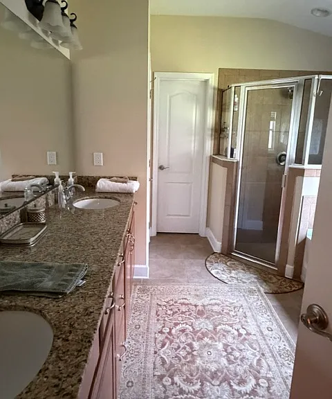 master bath with double sinks and walk in closet