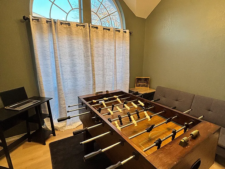 Bonus room. Has a desk for in house office days along with some fun games like foosball! Futon couch/bed as well.