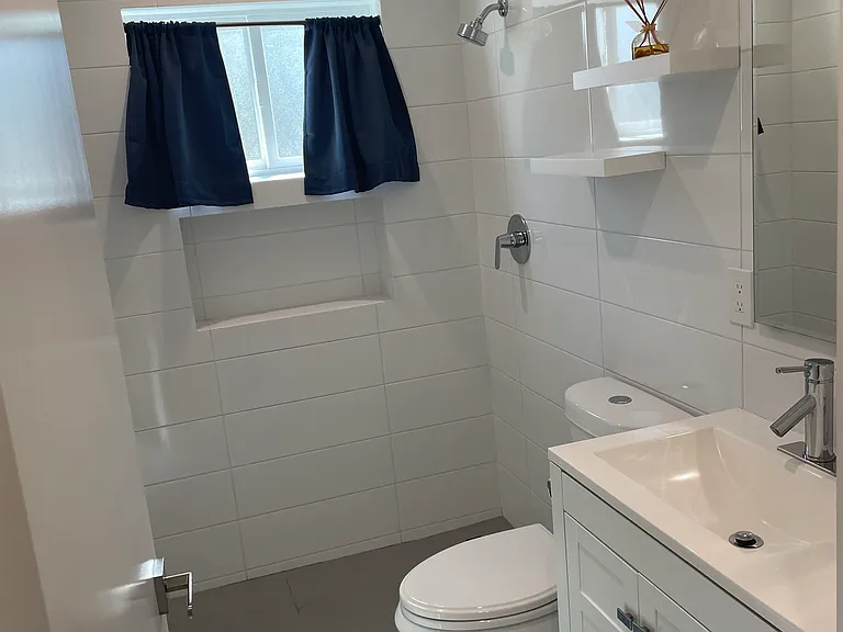 Master bathroom features curb less shower and built in niche.