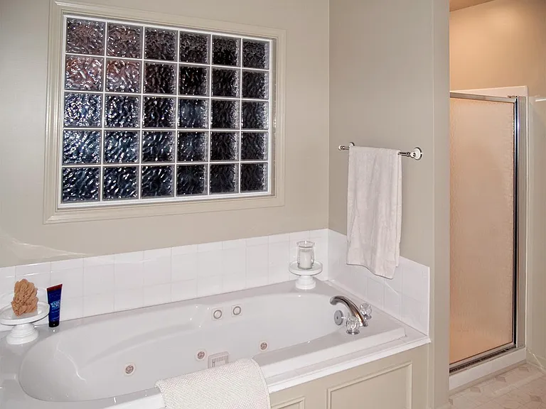 Jetted tub with separate shower.
