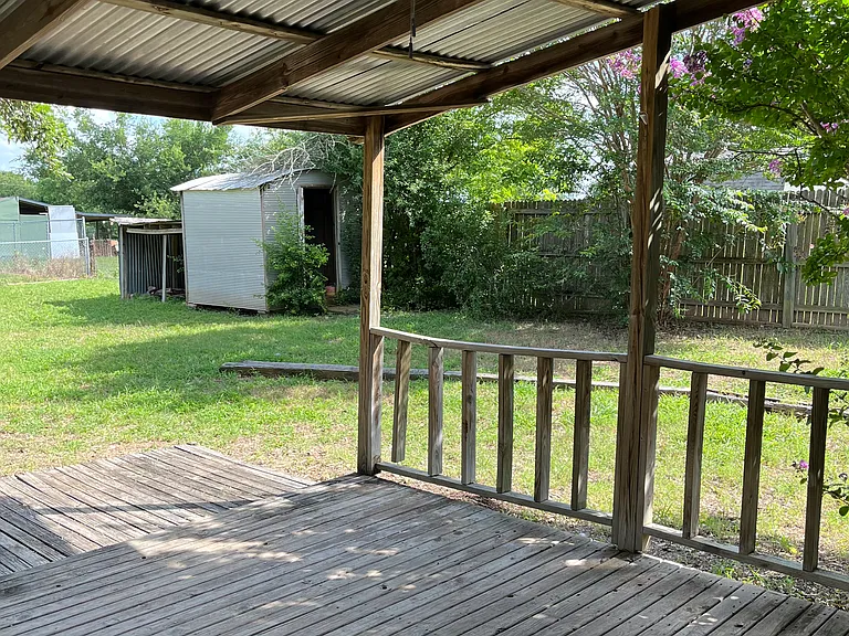 Covered back porch with fan and light.
