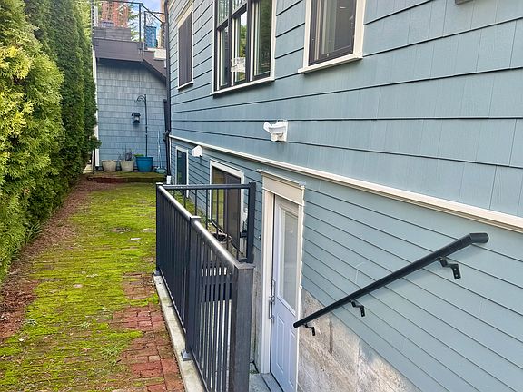 Private entrance with side yard/patio.