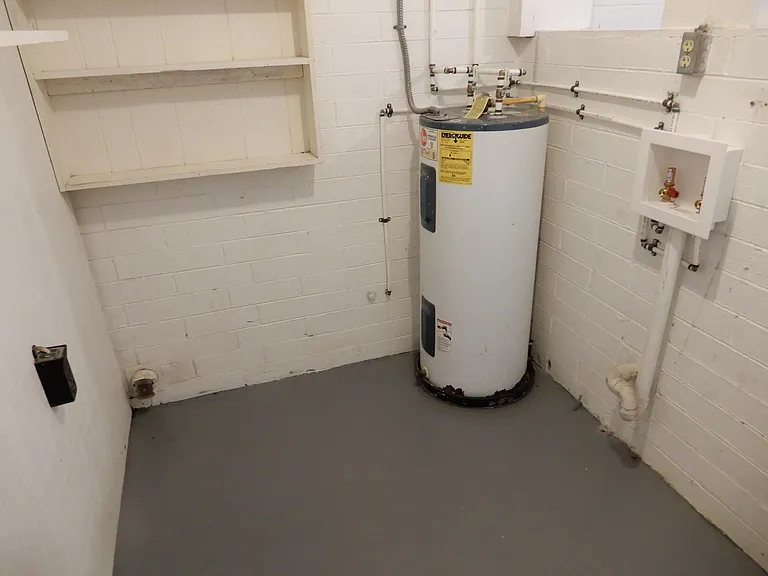 UTILITY ROOM WITH WASHER AND
DRYER HOOKUPS AND STORAGE AND HOBBY WORK BENCH.
