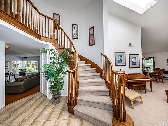 Entryway with beautiful spiral staircase.