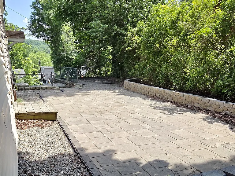 The first floor also enjoys a large private patio with flower beds and ample room for grilling.