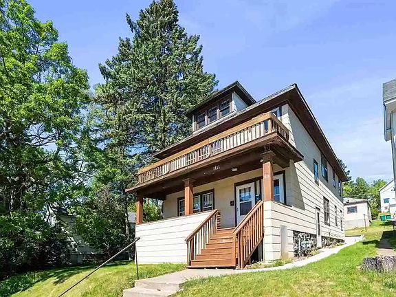 Street view of duplex with garage in back. Front entry to unit.
