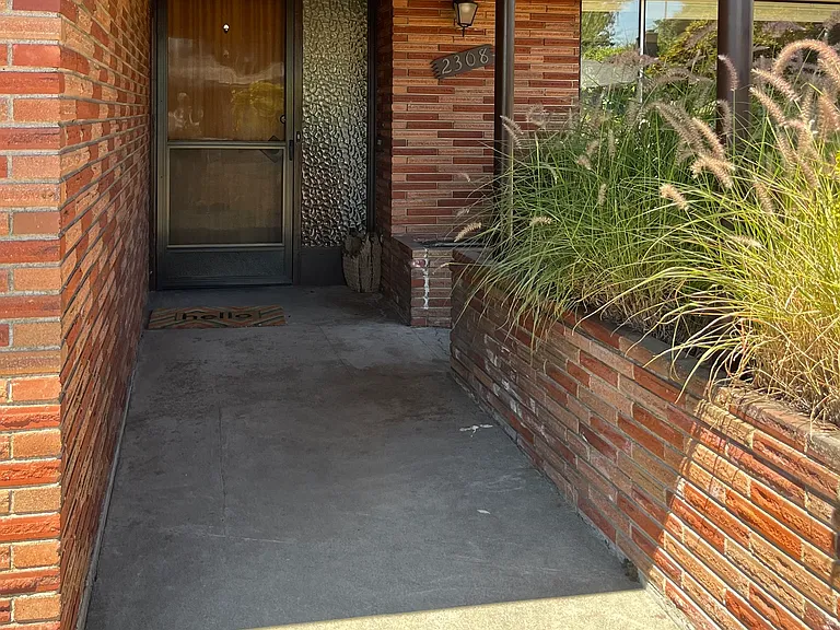 Covered entryway- lighted in the evenings. There are timed lights all around the eaves. Mid-century style.