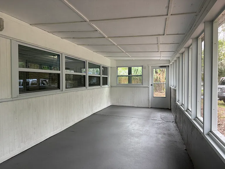 Enclosed back room with screened windows.