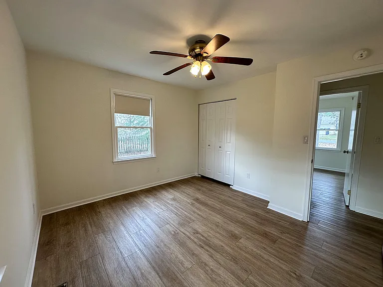 Bedroom #3 with a view of the side yard and backyard. This room features a larger closet.