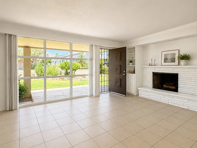 Big open living room with fireplace and mountain views from the 
front window and door!
