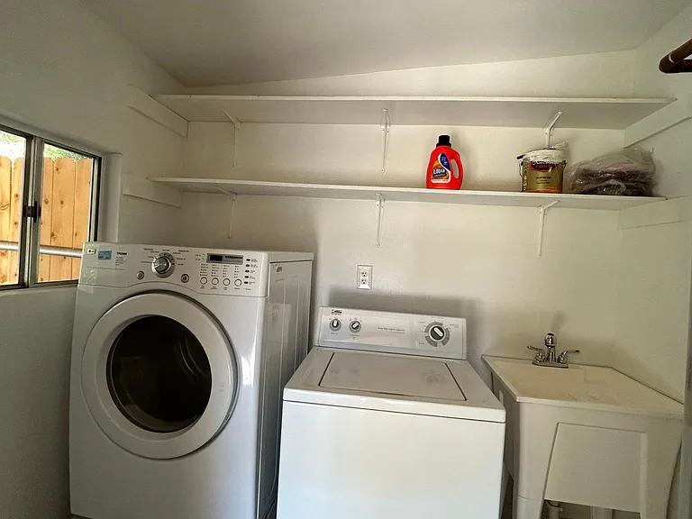 Washer and dryer located off of the patio