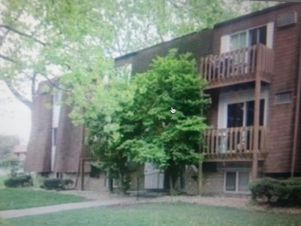Quiet building with lots of trees & green grass